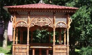 беседка, украшенная сеткой и резьбой